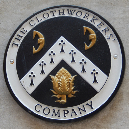 A roundel on St. Olaf's featuring a render of the component parts of the new coat of arms.
